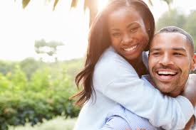 Smiling couple at a park in a sunny day