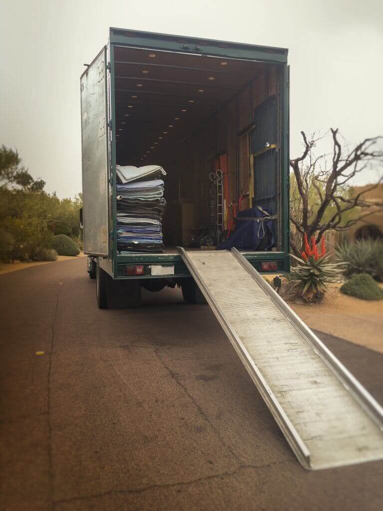 A moving truck unloading the furniture