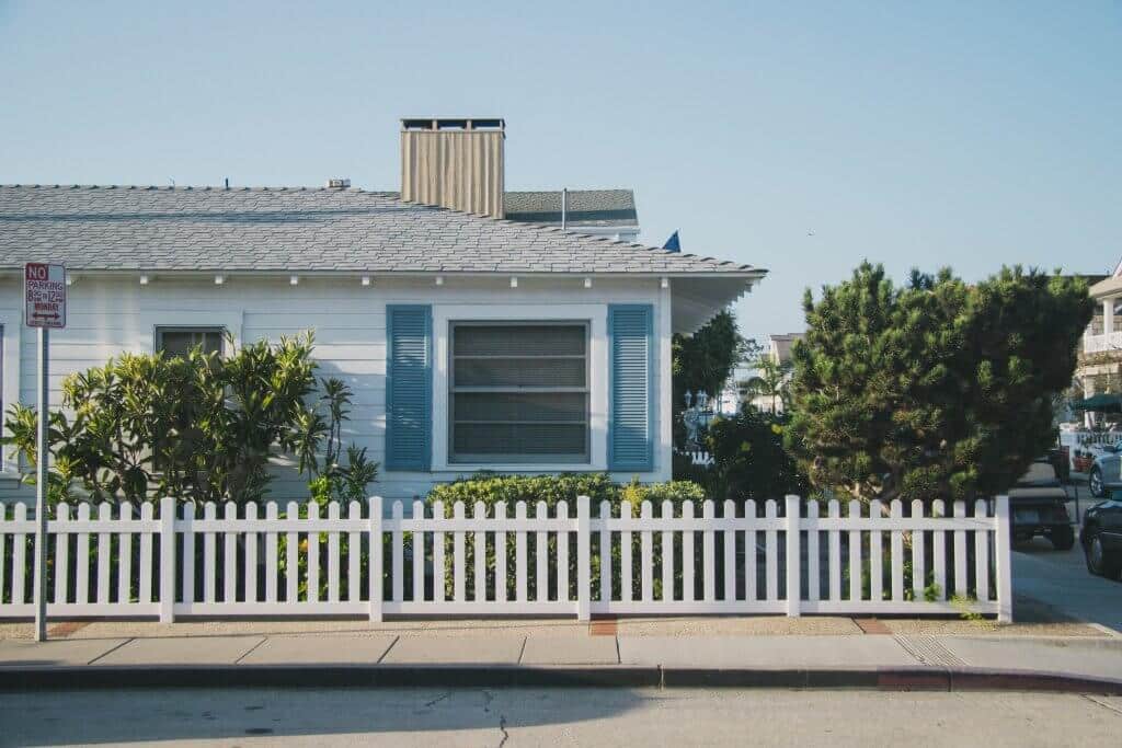 House with white fence in neighborhood