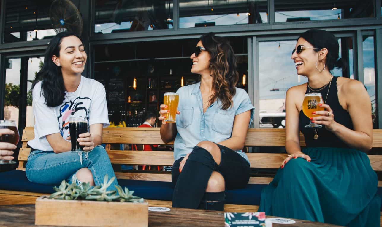 Women drink beer at the patio of the NYC local bar