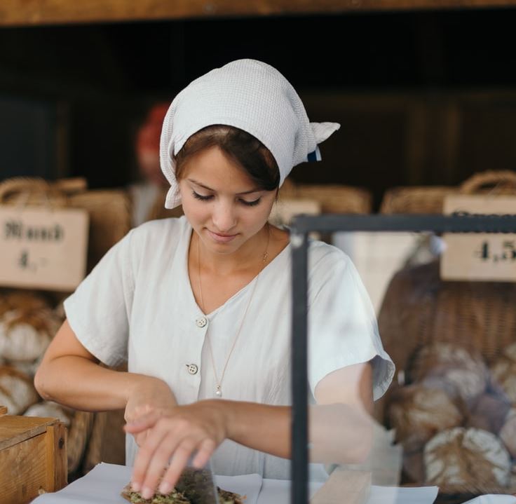 lady cutting meat outside